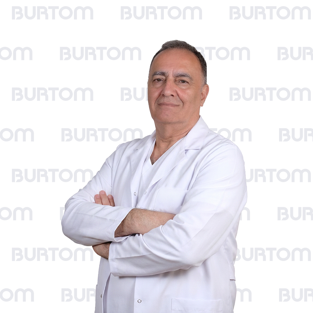 Male doctor in a white coat with arms crossed, looking confident.