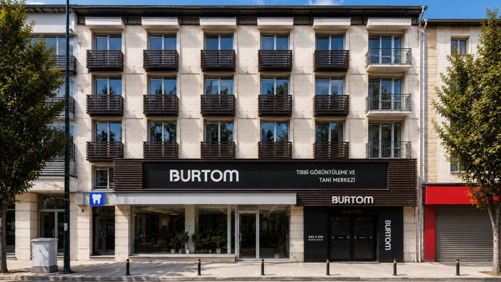 Beige, multistory building with dark wooden balconies; ground floor houses a Burtom dental center storefront with large windows and plants inside.